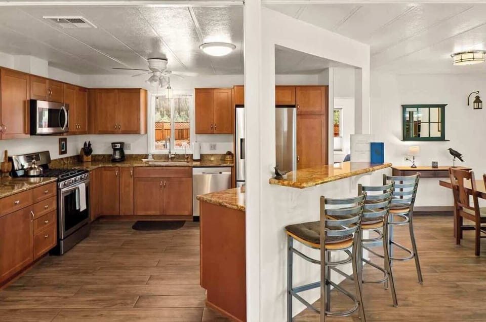 Fully equipped kitchen with modern appliances and a breakfast bar for easy meals.