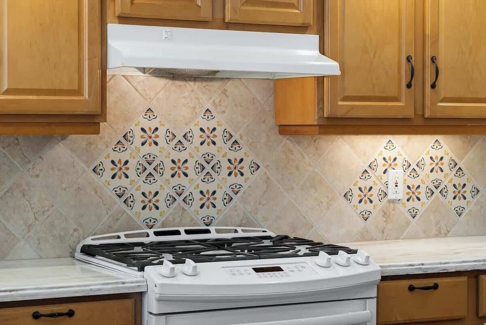 Prepare delicious meals in the well-appointed kitchen with charming tilework.