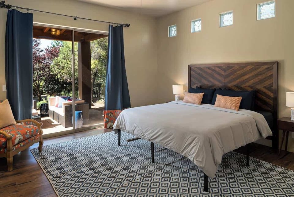 Rest peacefully in the spacious king bedroom with outdoor access and comfort.