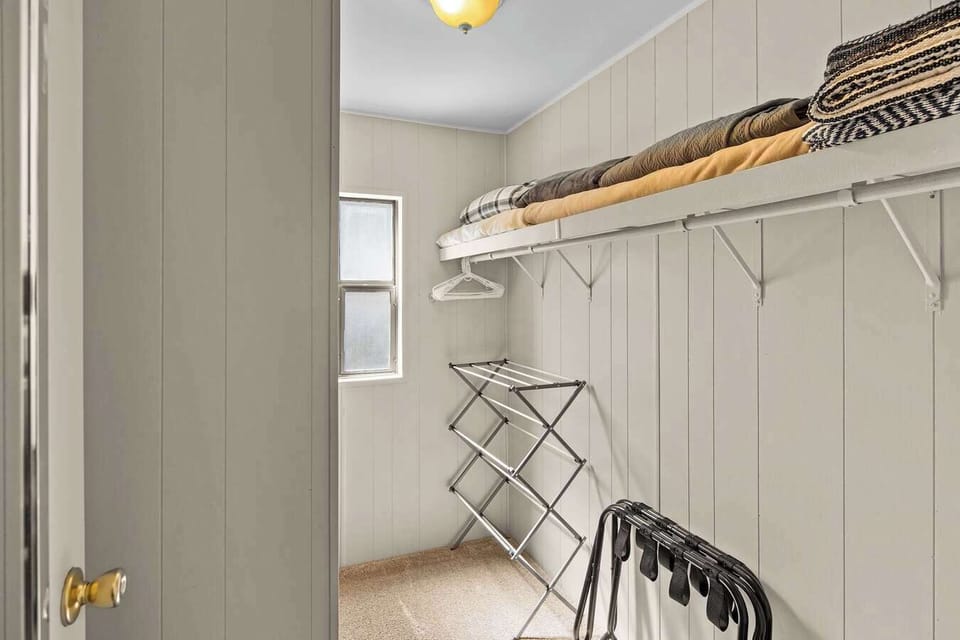 Convenient laundry area with a washer, dryer, and drying rack.