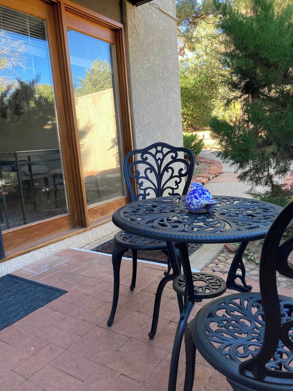 Enjoy your morning coffee or a peaceful evening on your private patio, featuring elegant wrought-iron seating and a relaxing view of the surrounding greenery. This cozy outdoor space offers a quiet spot to unwind and take in the fresh Sedona air.