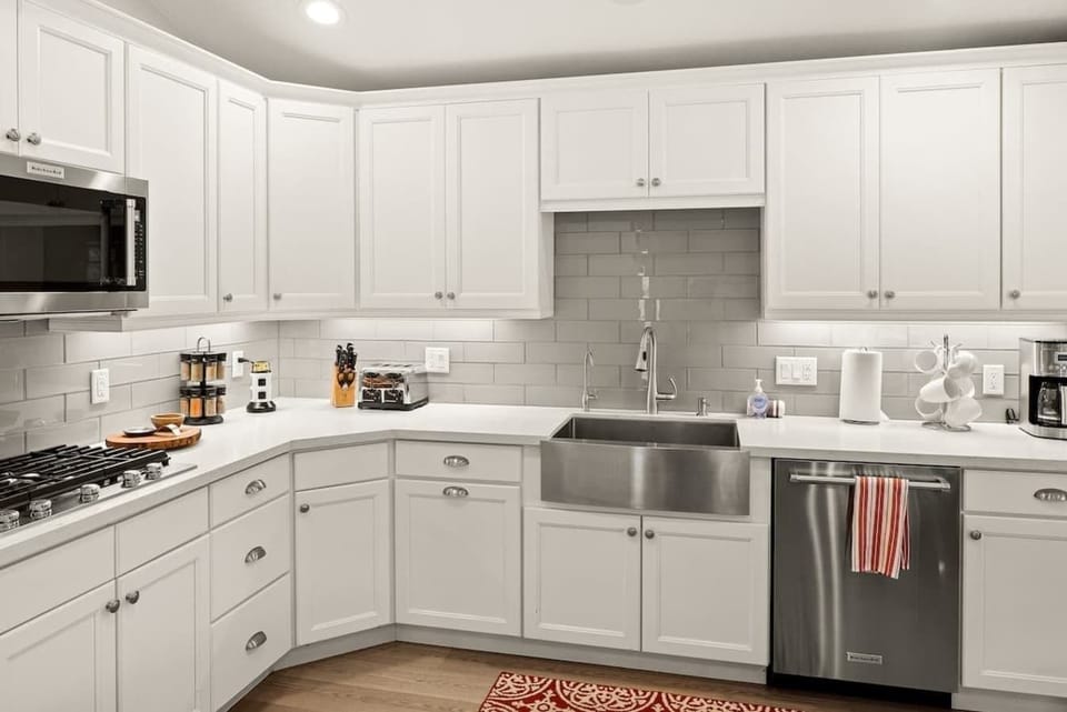 Fully stocked kitchen with paper towels, dish detergent, dish soap, new sponge and trash bags.