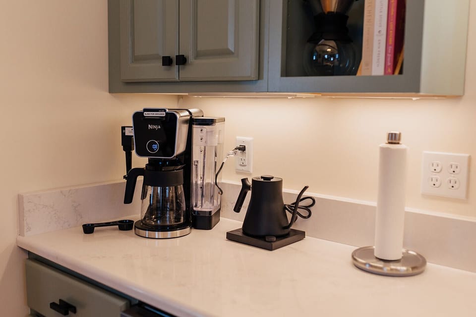 Brew the perfect cup with a versatile coffee maker that works with both ground coffee and K-cups, plus a pour-over option and an electric kettle for the ultimate coffee experience.