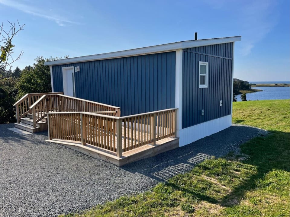 Rear view of cottage with option to walk up stairs or ramp which is designed for wheelchair