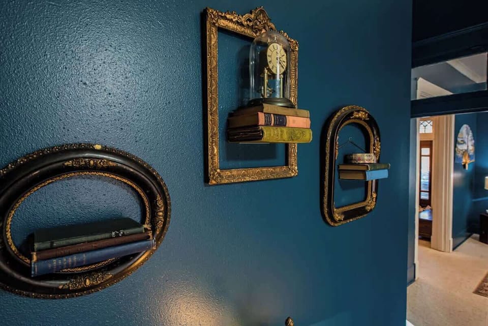 Admire unique design accents featuring vintage framed shelves with books and decor.