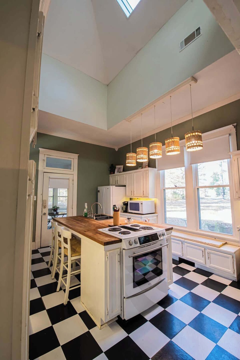 Prepare meals effortlessly in a bright kitchen with high ceilings, skylights, and a central island.