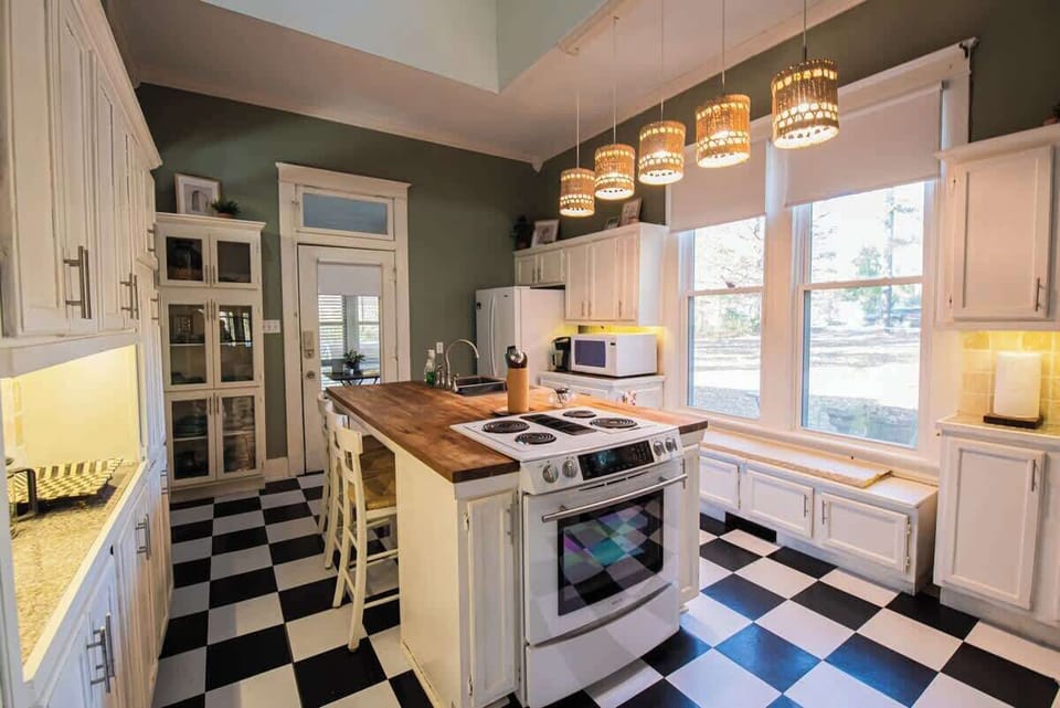 Cook with ease in a fully equipped kitchen featuring a center island and butcher block countertops.