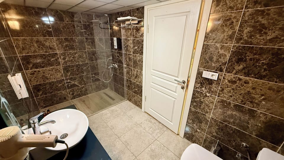 Standard Double Room | Bathroom | Shower, hair dryer, towels, soap