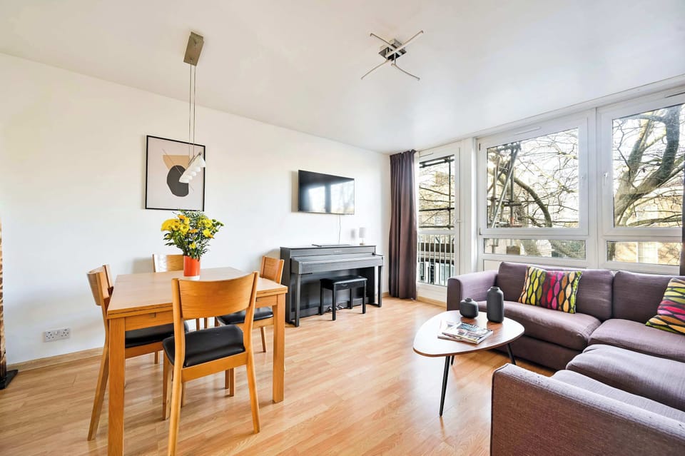 Bright and spacious living area with a piano! 