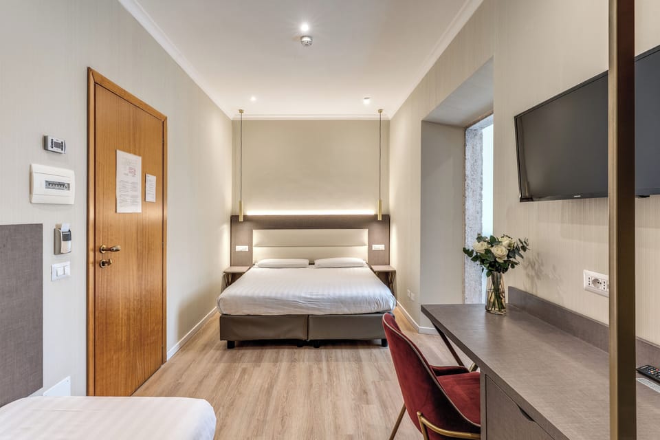 Triple Room | Minibar, in-room safe, desk, iron/ironing board