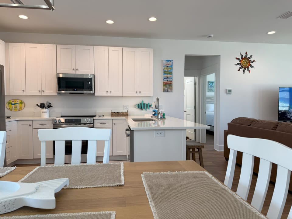 equipped kitchen has stainless steel appliances, and an eat in breakfast bar 