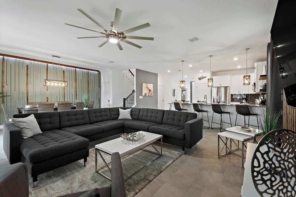 Relax and unwind in our cozy living room after a day of exploring Orlando's attractions, including nearby Disney World. Kick back on the comfortable couch and enjoy your favorite shows on the flat-screen TV, or spend quality time with loved ones.