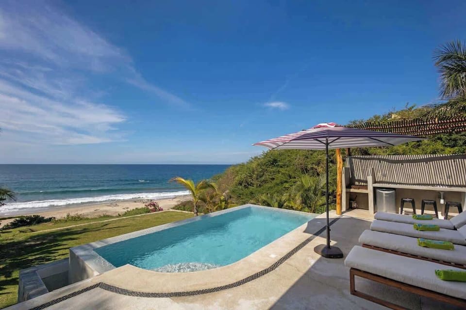 Pool and patio with ocean views