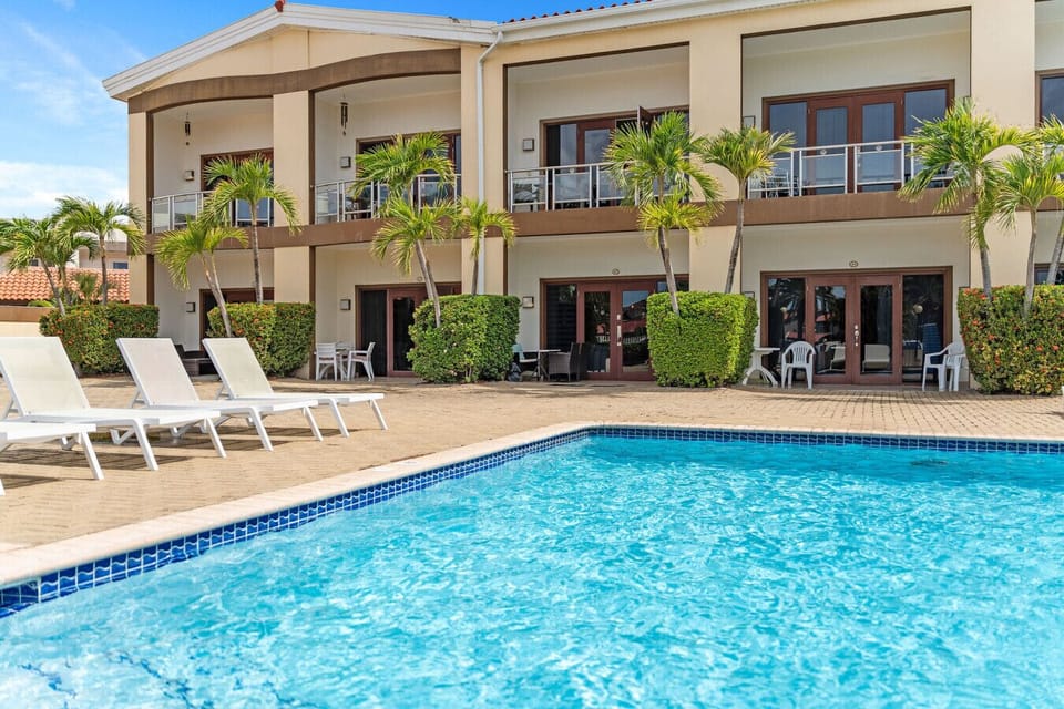 Unwind at the beautiful community pool surrounded by comfortable sun loungers. The perfect spot to relax, soak up the sun, and slow down island time.