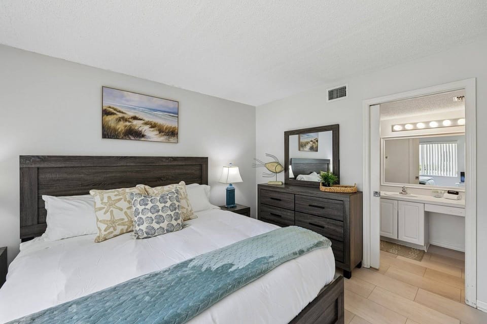 Spacious primary suite with plush king bed and en-suite bathroom