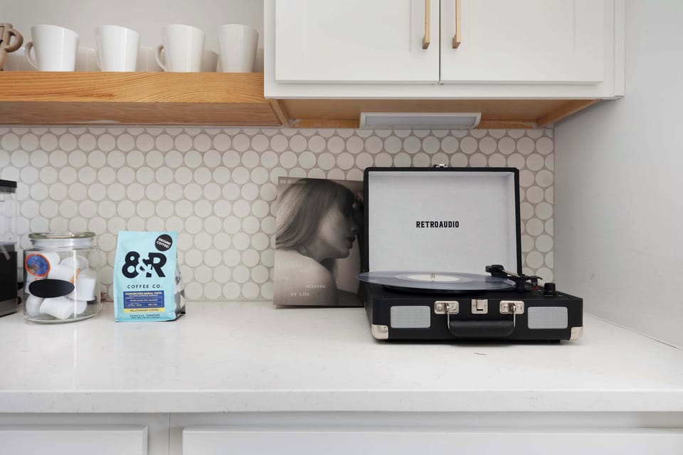 Clean and Spacious Kitchen with Sleek Countertops and Additional Seating