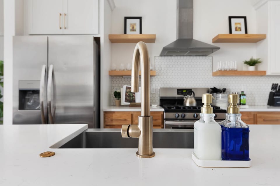 Clean and Spacious Kitchen with Sleek Countertops and Additional Seating