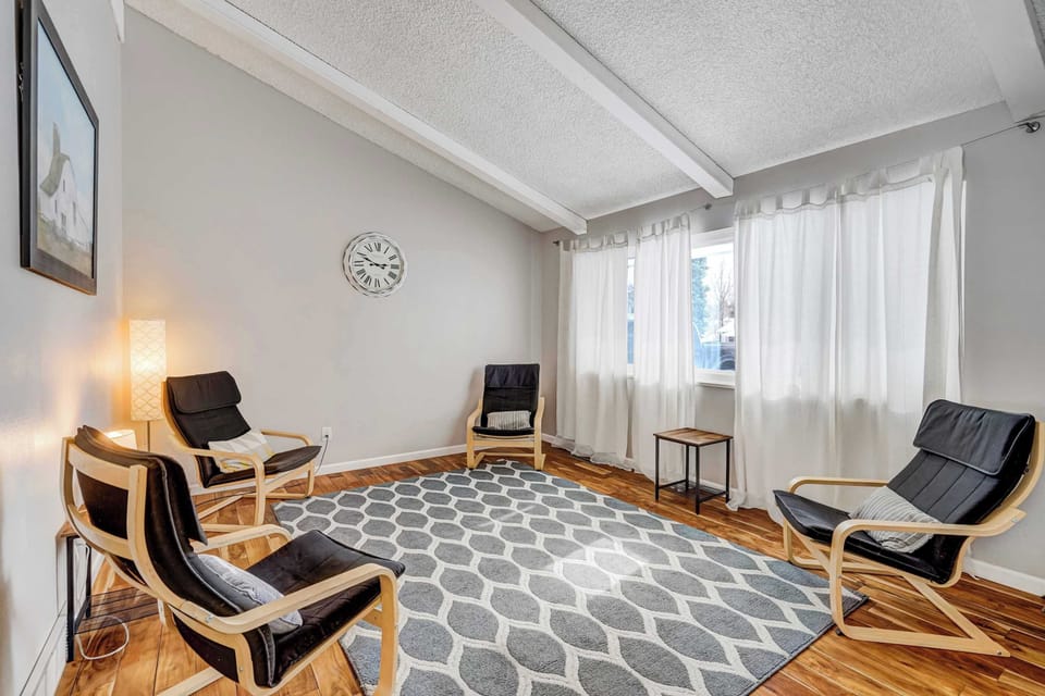 This cozy seating area offers a relaxing space to unwind, featuring stylish armchairs, soft lighting, and natural light streaming through large windows. Perfect for reading or enjoying a quiet moment.



