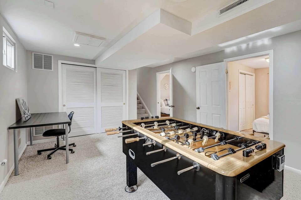 This versatile game and workspace features a foosball table, a wall-mounted TV, and a dedicated desk area—perfect for both entertainment and productivity. A great space to unwind or catch up on work.





