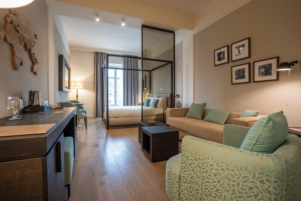 Suite, River View | Minibar, in-room safe, desk, laptop workspace