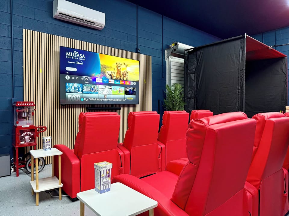 Game room: HUGE 85" 4K TV with surround sound, fully reclining move theater massage chairs & popcorn machine!