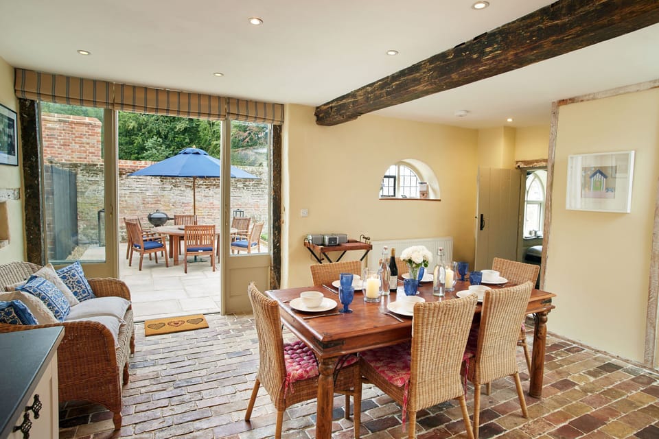 The Kitchen doors lead out onto the terraced area with Barlow Tyrie garden furniture