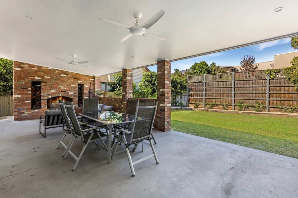 Backyard with undercover patio and ample seating. This backyard is fully-fenced making it perfect for families.