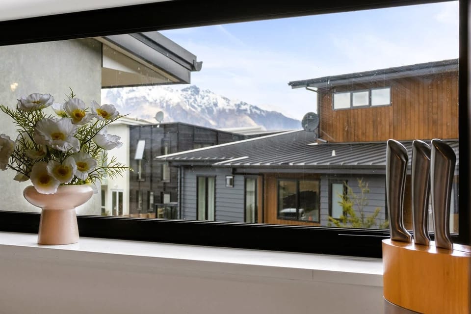 Kitchen window view showcasing nearby mountains