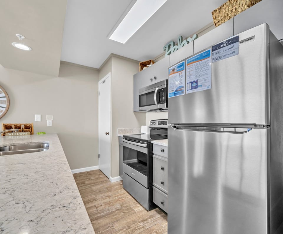 Cook with ease in the fully equipped kitchen, featuring modern appliances.