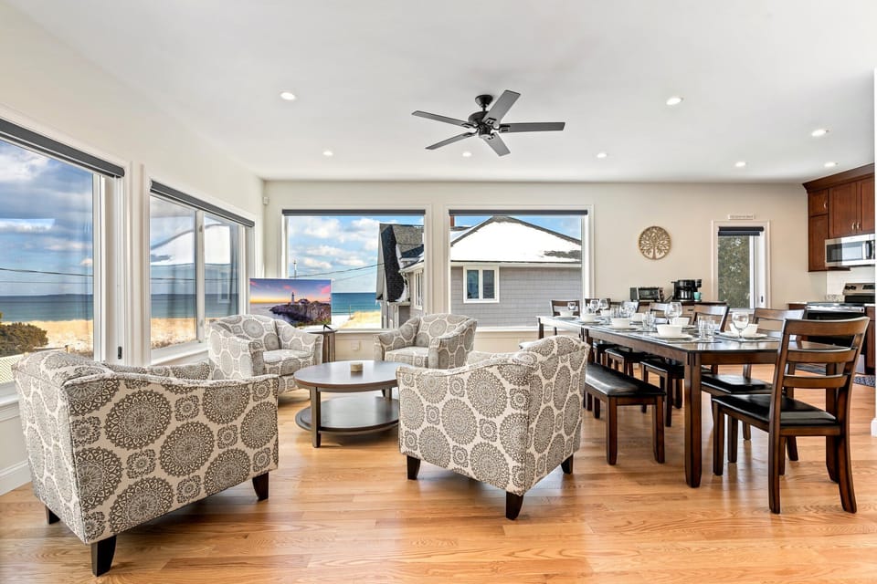 Living area with ample seating, TV, and ocean view