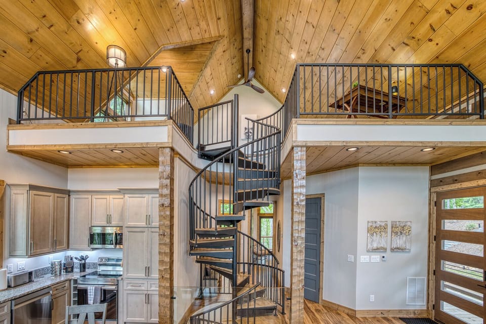 Ascend the spiral staircase to the game loft with workspace, poker table, shuffleboard, board games and mountain view!