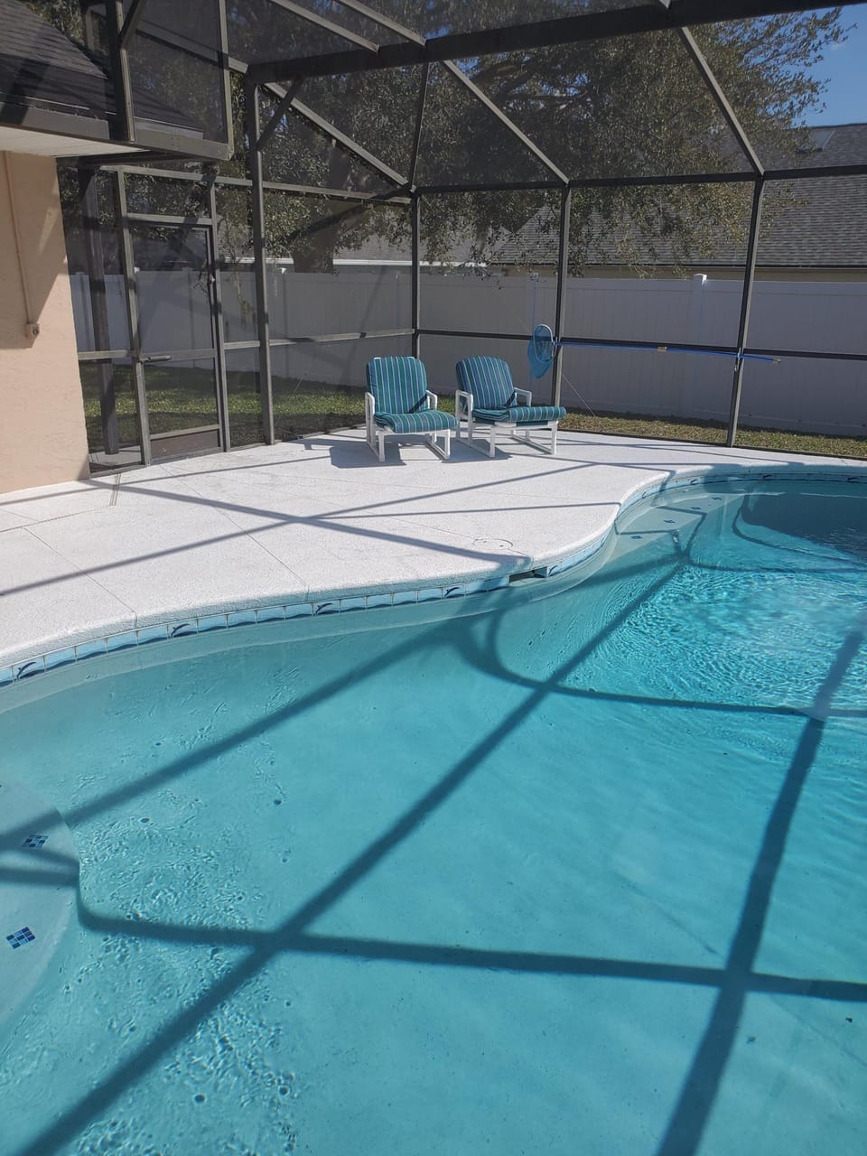 South west facing pool with privacy fence