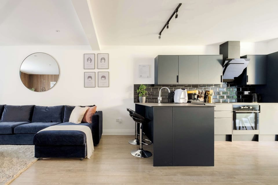 Living Room | Elevated comfort in a spacious air conditioned living area with 70 Inch TV and an open plan kitchen leading to a private garden, complete with a PS5 for relaxed entertainment, creating the perfect setting to enjoy your holiday in style.