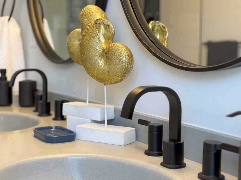 A double-sink vanity with mirrors adds to the convenience of the Primary Suite’s ensuite bathroom.