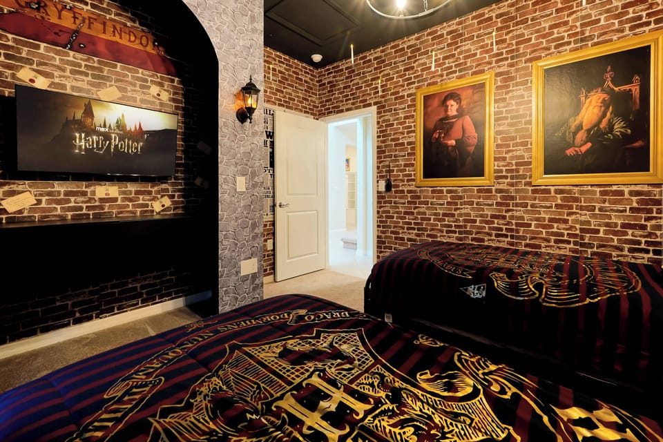 Experience a whimsical getaway in this uniquely themed bedroom, where striking brick walls and captivating artwork blend with rich bed linens to create a cozy yet adventurous atmosphere perfect for your stay.