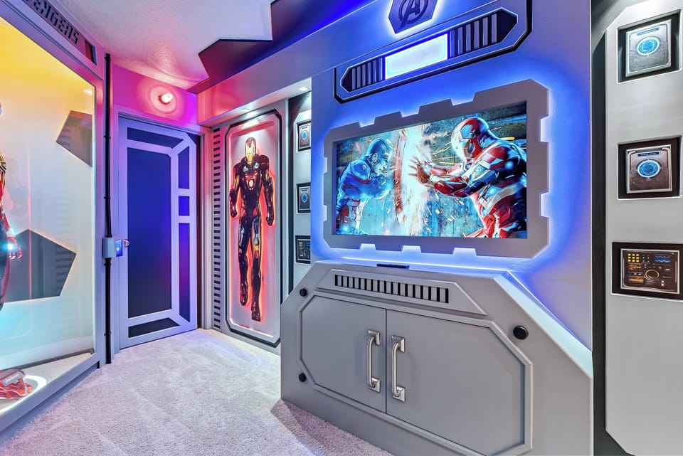 Step into a vibrant entertainment room with dynamic artwork and glowing accents that set an exciting atmosphere. Enjoy movie nights on the big screen, surrounded by impressive superhero displays that thrill fans of all ages.