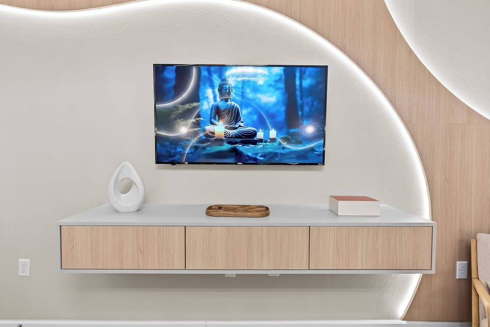 Enjoy a modern design with a sleek wall-mounted TV that invites relaxation. The soft glow enhances the natural wood tones of the stylish console, creating a cozy atmosphere perfect for unwinding or entertaining guests.