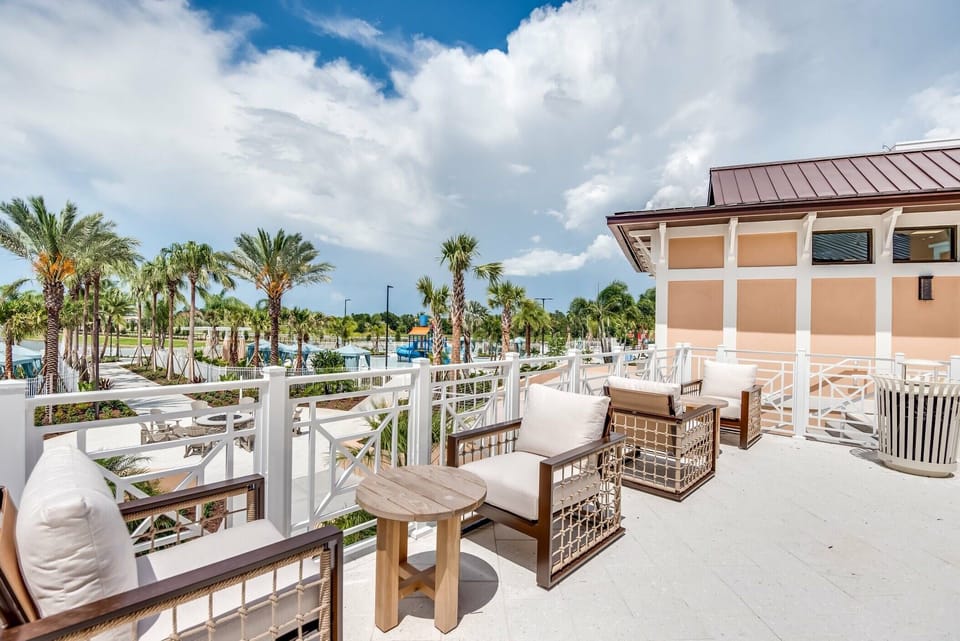 Step outside to a spacious terrace with cozy wicker seating and a lovely wooden table, ideal for your morning coffee. Enjoy the gentle sway of lush palm trees, creating a peaceful atmosphere that beckons you to unwind.
