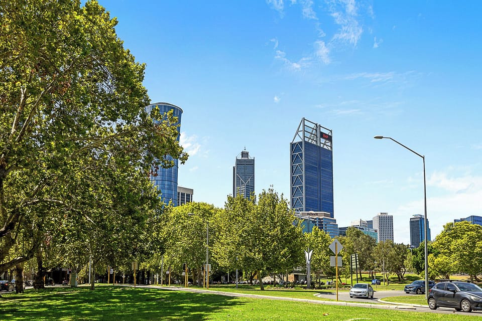 Enjoy the outdoors with a park view, showcasing lush greenery and a stunning city skyline.