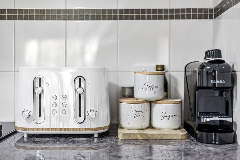 Start your day with convenience, featuring a toaster, coffee maker, and organized storage for your morning essentials.