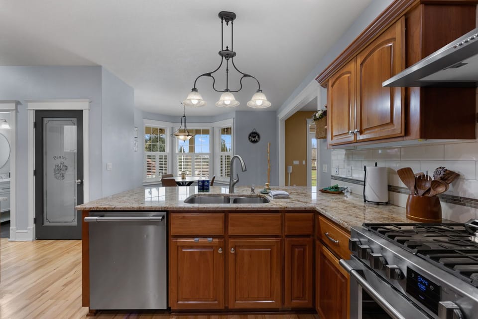 Modern kitchen featuring a gas stove, dishwasher, extra dining space, and everything you need for effortless cooking and entertaining during your stay.