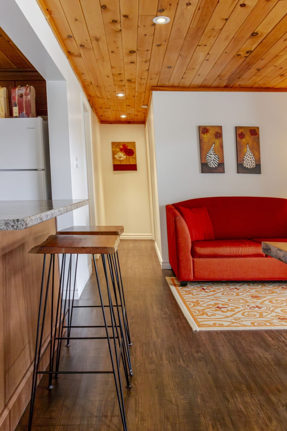 The kitchen overlooks the dining table and living room beyond