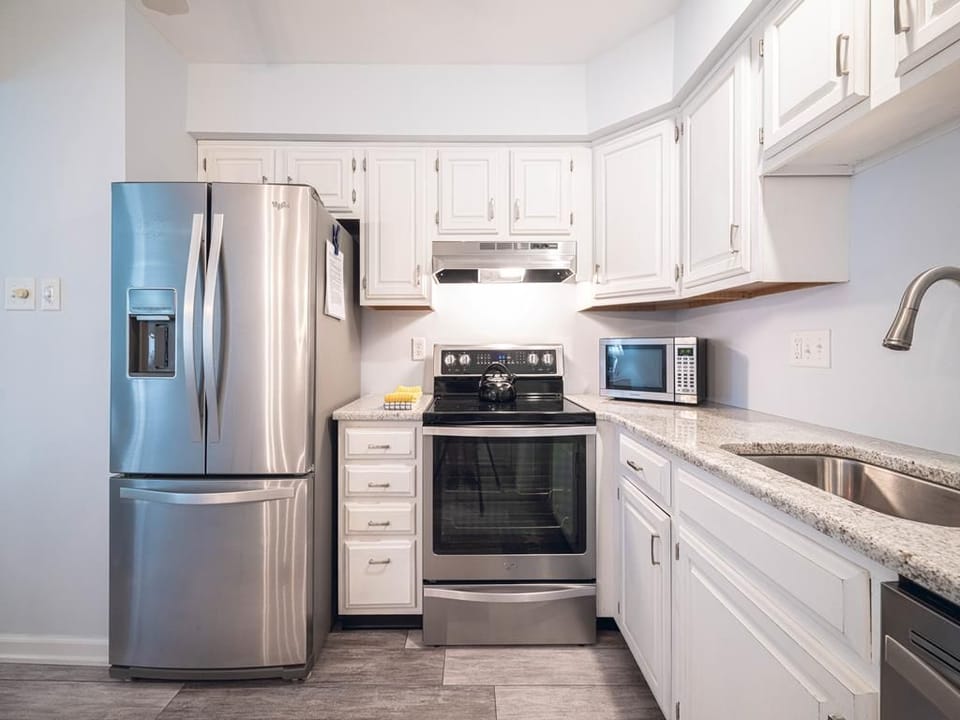 Stainless steel appliances and white cabinetry give a sleek, updated feel.