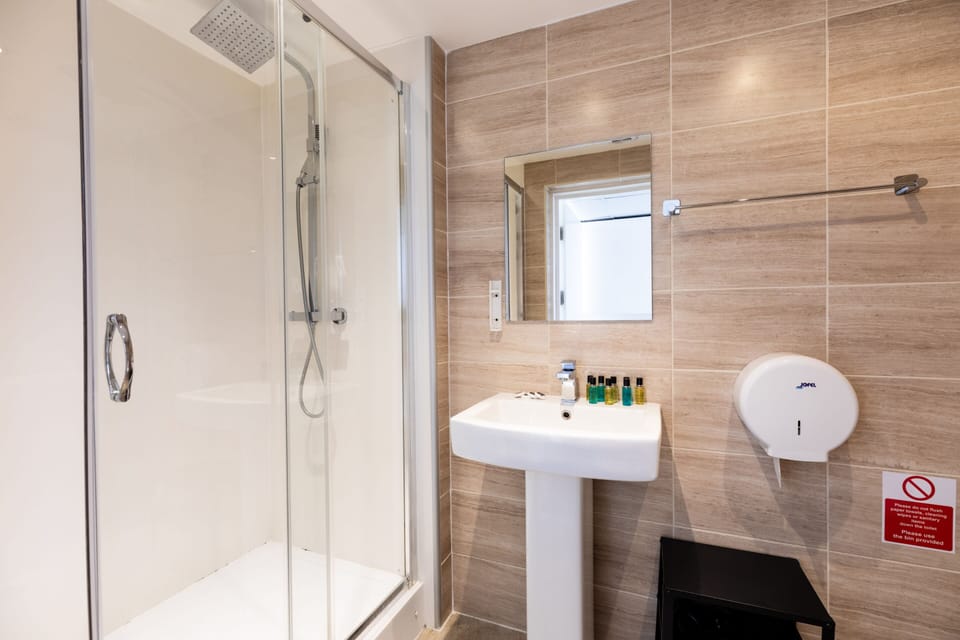 Deluxe Studio, Private Bathroom (Family Quad) | Bathroom | Shower, free toiletries, hair dryer, towels
