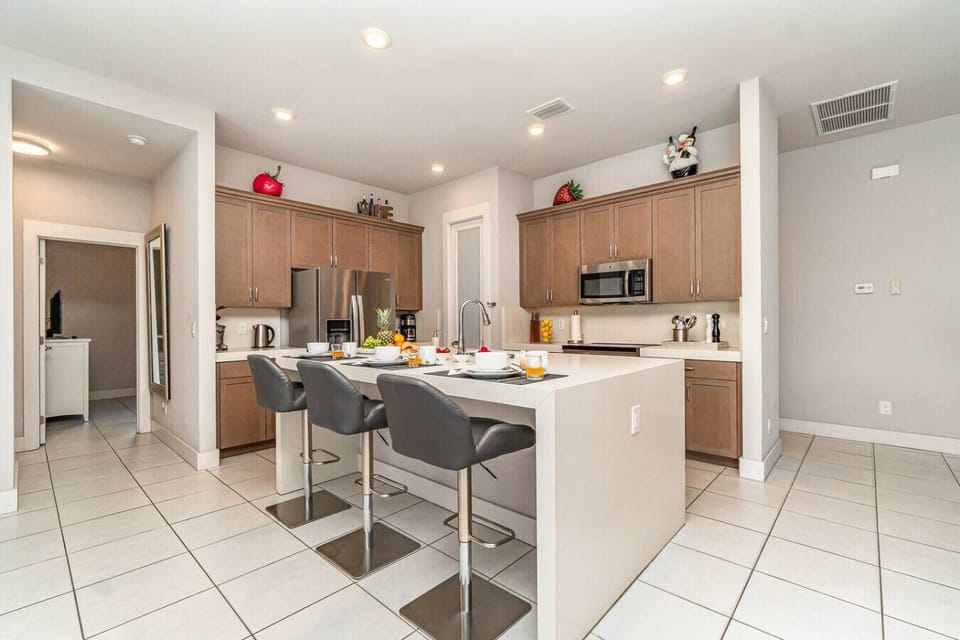 Modern and fully-equipped kitchen with spacious breakfast bar, perfect for quick meals or entertaining guests.