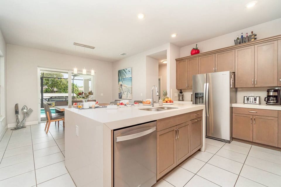 Spacious fully-equipped kitchen with modern appliances and large island, great for preparing family meals.