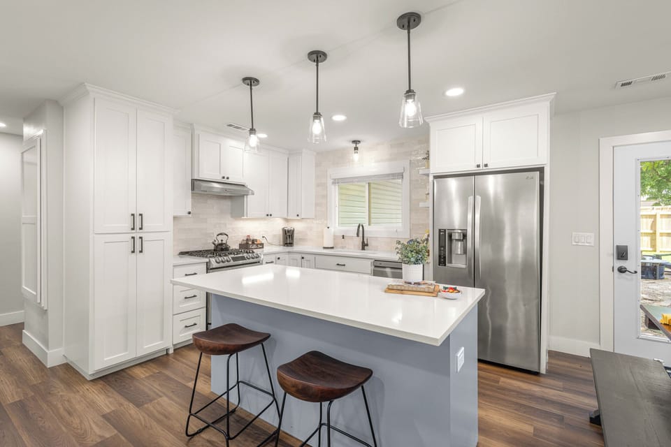 Renovated kitchen with stainless appliance, gas stove, convection oven, and quartz countertops