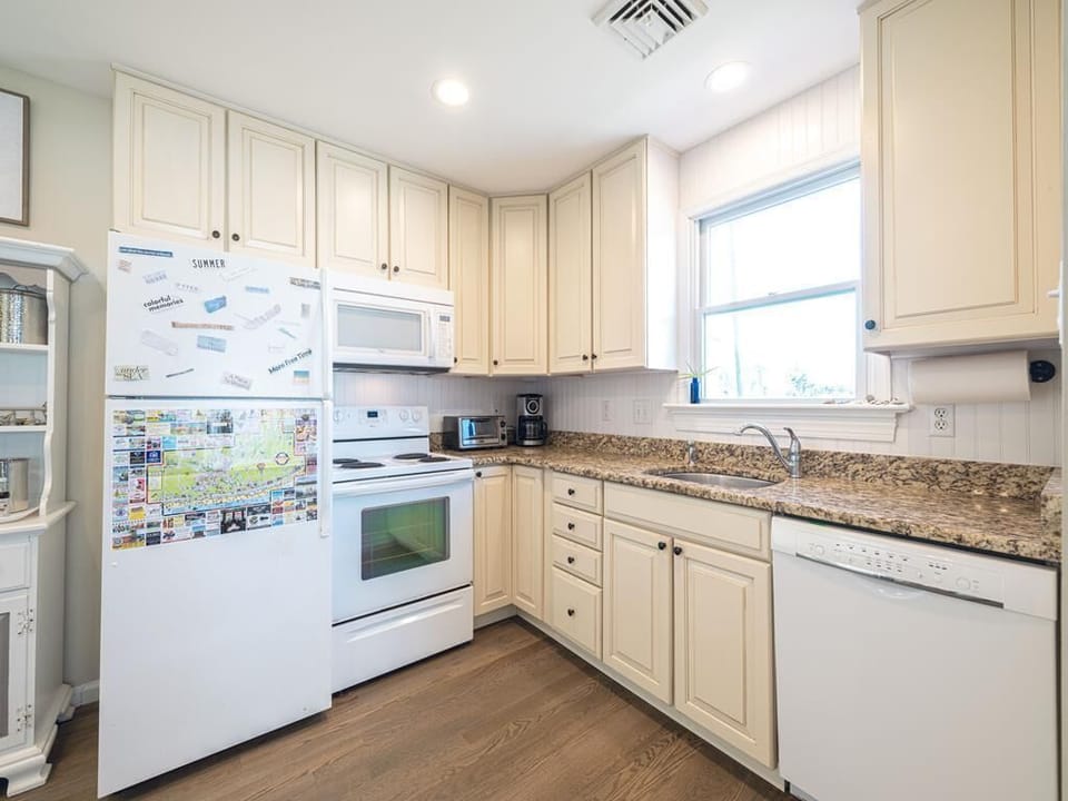 A cozy and functional kitchen with classic cabinetry and modern appliances.