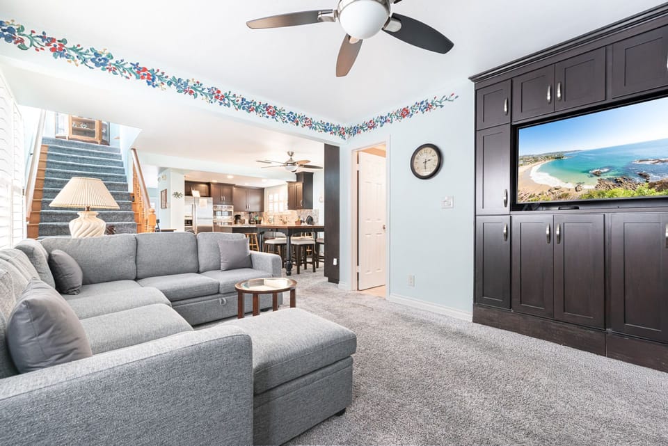 Comfortable lounge with built-in media wall for relaxed nights in
                