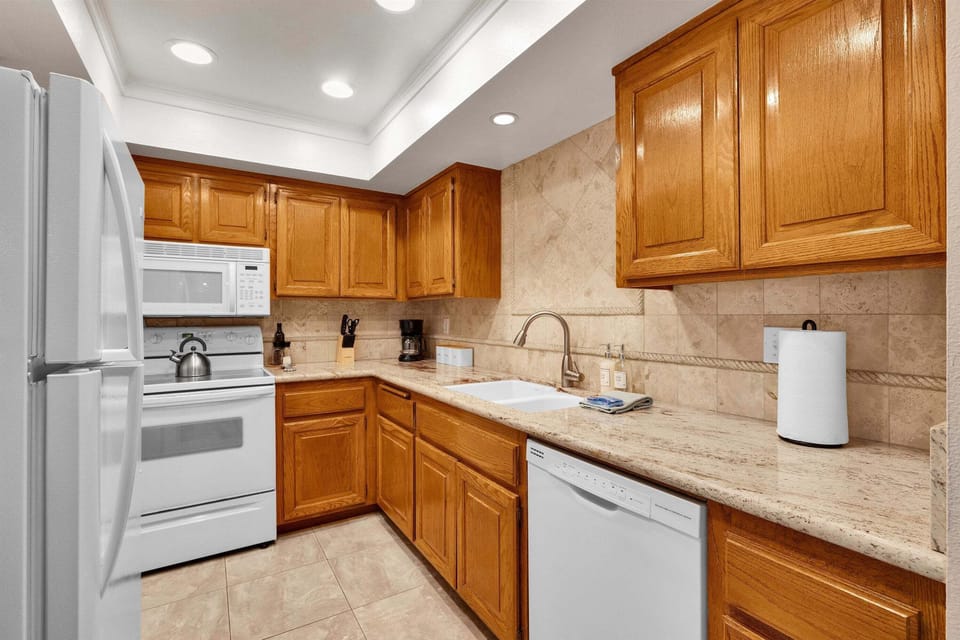 Fully equipped kitchen with granite counters and modern appliances